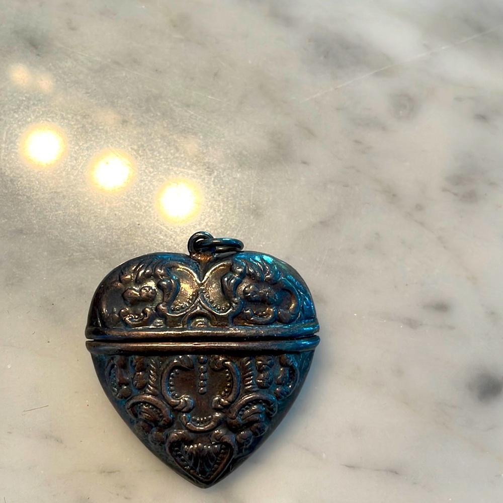 Antique locket with lucky charms inside sterling